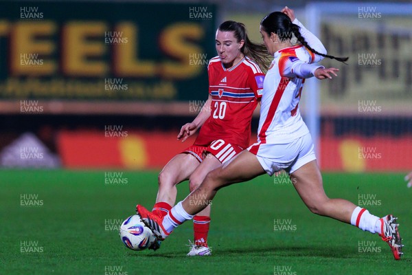 070326 - Wales v Montenegro - 2027 FIFA Women's World Cup Qualifying - Carrie Jones of Wales is challenged by Selma Licina of Montenegro