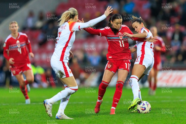 070326 - Wales v Montenegro - 2027 FIFA Women's World Cup Qualifying - Hannah Cain of Wales is challenged by Darija Dukic of Montenegro