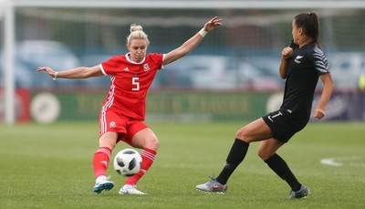 040619 - Wales v New Zealand, Women's International Challenge Match - Rhiannon Roberts of Wales plays the ball past Ali Riley of New Zealand