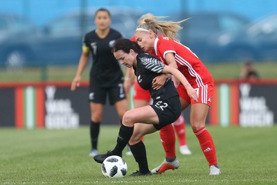 040619 - Wales v New Zealand, Women's International Challenge Match - Olivia Chance of New Zealand holds off Charlie Estcourt of Wales