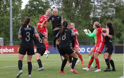 040619 - Wales v New Zealand, Women's International Challenge Match - Rhiannon Roberts of Wales looks to head at goal as Hannah Wilkinson of New Zealand challenges