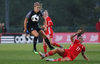 040619 - Wales v New Zealand, Women's International Challenge Match - Rosie White of New Zealand fires a shot at goal as Natasha Harding of Wales closes in to challenge