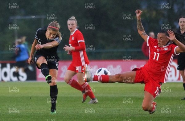 040619 - Wales v New Zealand, Women's International Challenge Match - Rosie White of New Zealand fires a shot at goal as Natasha Harding of Wales closes in to challenge