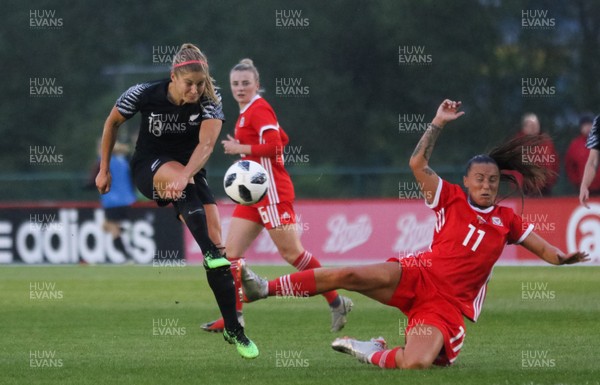 040619 - Wales v New Zealand, Women's International Challenge Match - Rosie White of New Zealand fires a shot at goal as Natasha Harding of Wales closes in to challenge