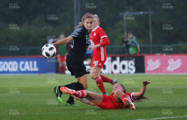 040619 - Wales v New Zealand, Women's International Challenge Match - Rosie White of New Zealand fires a shot at goal as Natasha Harding of Wales closes in to challenge