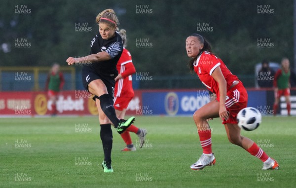 040619 - Wales v New Zealand, Women's International Challenge Match - Rosie White of New Zealand fires a shot at goal as Natasha Harding of Wales closes in to challenge