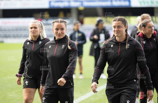 281023 - Wales Women v New Zealand Women, WXV1 - Jasmine Joyce of Wales and Robyn Wilkins of Wales walk out on the pitch ahead of Wales v New Zealand in Dunedin