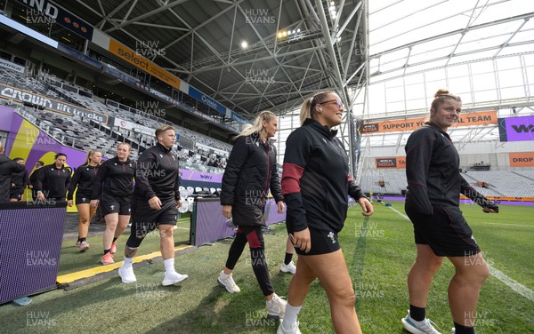 281023 - Wales Women v New Zealand Women, WXV1 - Kate Williams, Kelsey Jones, Carys Williams-Morris and Donna Rose of Wales walk out on the pitch ahead of Wales v New Zealand in Dunedin