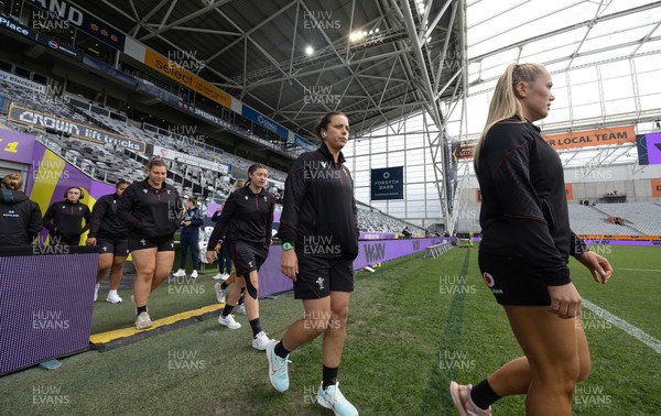 281023 - Wales Women v New Zealand Women, WXV1 - Meg Webb, Sioned Harries, Robyn Wilkins and Gwenllian Pyrs of Wales walk out on the pitch ahead of Wales v New Zealand in Dunedin