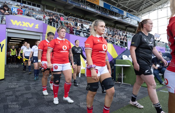 281023 - Wales Women v New Zealand Women, WXV1 - Alex Callender of Wales, Donna Rose of Wales and Sisilia Tuipulotu of Wales walk out at the start of the match