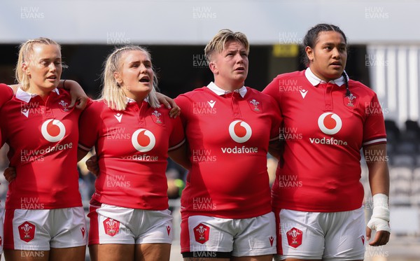 281023 - Wales Women v New Zealand Women, WXV1 -  Left to right, Meg Webb, Alex Callender, Donna Rose and Sisilia Tuipulotu line up for the anthems at the start of the match