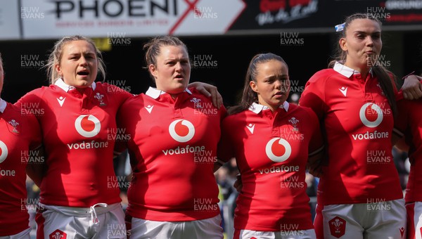 281023 - Wales Women v New Zealand Women, WXV1 -  Left to right, Hannah Bluck, Abbey Constable, Meg Davies and Bryonie King line up for the anthems at the start of the match