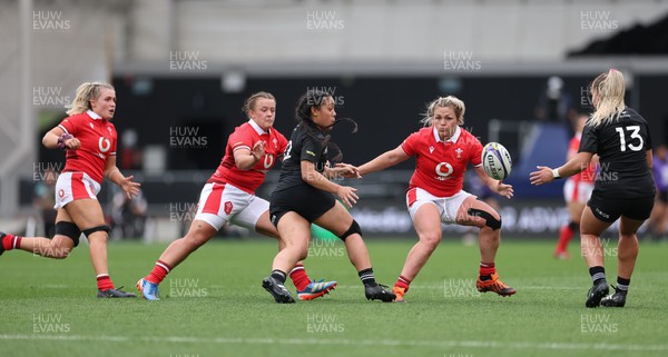 281023 - Wales Women v New Zealand Women, WXV1 - Logo-I-Pulotu Lemapu Atai'i of New Zealand passes to Amy du Plessis of New Zealand as Alex Callender of Wales, Lleucu George of Wales and Hannah Bluck of Wales close in