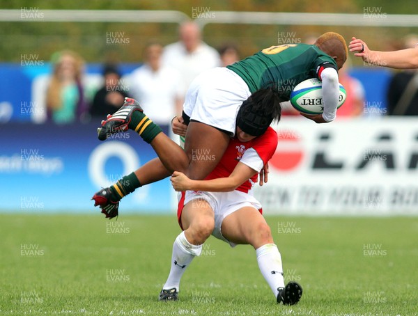  Huw Evans Agency 2010 - Ceri Redman lifts SA Lamla Momoti off her feet in the tackle - Wales v South Africa  - Women's  Rugby World Cup - Surrey Sports Park - 24/08/2010 - All rights reserved