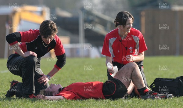 02.02.08 The Women's 6 Nations. Wales vs. Scotland. Taffs Well RFC, Cardiff, Wales. 
 
Physio Sian Hughes(R) treats prop Jenny Davies as Liza Burgees oversees. 
 
