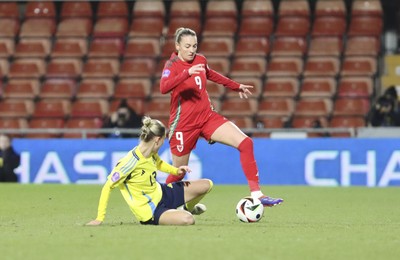 250225 - Wales v Sweden - UEFA Women's Nations League - Emma Kullberg of Sweden and Kayleigh Barton of Wales