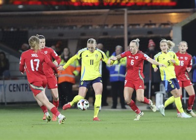 250225 - Wales v Sweden - UEFA Women's Nations League - Stina Blackstenius of Sweden takes on Josie Green of Wales