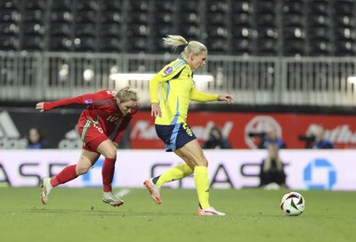 250225 - Wales v Sweden - UEFA Women's Nations League - Jessica Fishlock Wales chases down Jonna Andersson of Sweden