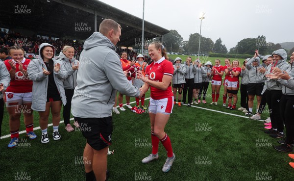 300923 - Wales Women v USA Women, International Test Match - Carys Cox of Wales is presented with her first cap at the end of the match by Wales head coach Ioan Cunningham