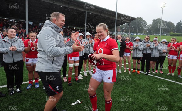 300923 - Wales Women v USA Women, International Test Match - Carys Cox of Wales is presented with her first cap at the end of the match by Wales head coach Ioan Cunningham