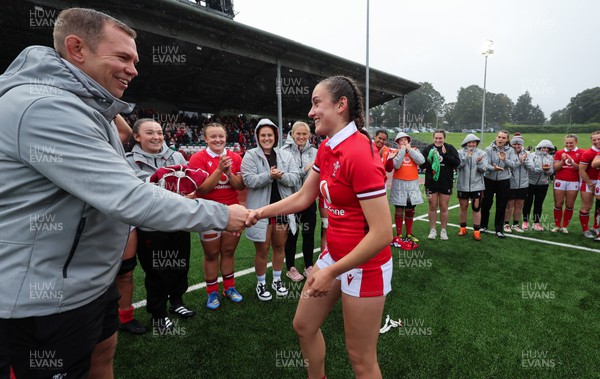 300923 - Wales Women v USA Women, International Test Match - Nel Metcalfe of Wales is presented with her first cap at the end of the match by Wales head coach Ioan Cunningham