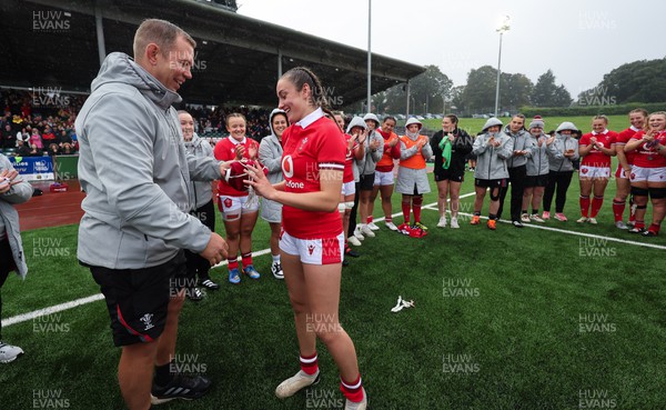 300923 - Wales Women v USA Women, International Test Match - Nel Metcalfe of Wales is presented with her first cap at the end of the match by Wales head coach Ioan Cunningham