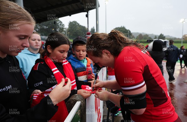 300923 - Wales Women v USA Women, International Test Match - Abbie Fleming of Wales signs autographs at the end of the match