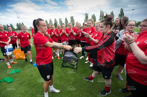 030619 - Wales Women's Football Squad Training Session - Natasha Harding of the Wales' Womens football squad presents members of the Wales Homeless Football squad with spare boots and kits that the team had donated to help the Homeless team with their preparations for the Homeless World Cup