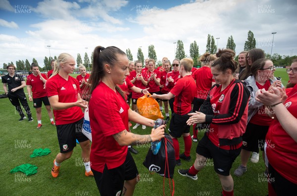 030619 - Wales Women's Football Squad Training Session - Natasha Harding of the Wales' Womens football squad presents members of the Wales Homeless Football squad with spare boots and kits that the team had donated to help the Homeless team with their preparations for the Homeless World Cup