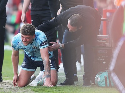 210326 - Walsall v Newport County - Sky Bet League 2 - Cameron Evans of Newport is helped up by a concerned Newport manager Christian Fuchs
