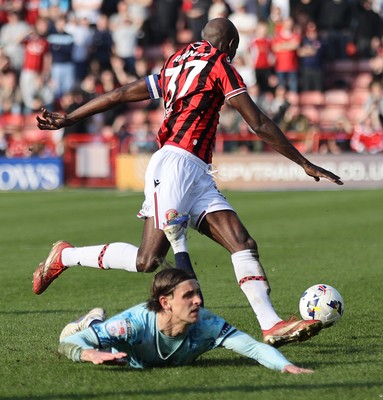 210326 - Walsall v Newport County - Sky Bet League 2 - Albert Adman of Walsall FC leaps over Harrison Biggins of Newport