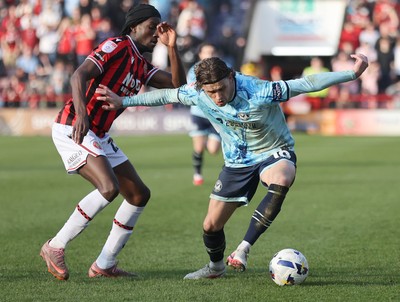210326 - Walsall v Newport County - Sky Bet League 2 - Harrison Biggins of Newport and Jid Okeke of Walsall FC