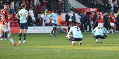 210326 - Walsall v Newport County - Sky Bet League 2 - Anthony Glennon of Newport and Matt Baker of Newport and Harrison Biggins of Newport dejected at the end of the match