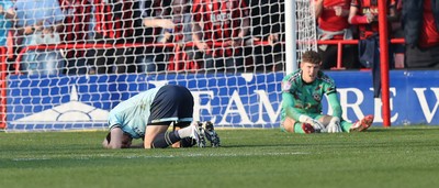 210326 - Walsall v Newport County - Sky Bet League 2 - Tom Davies of Newport and Goalkeeper Jordan Wright are floored with Anthony Glennon of Newport with his face in his shirt
