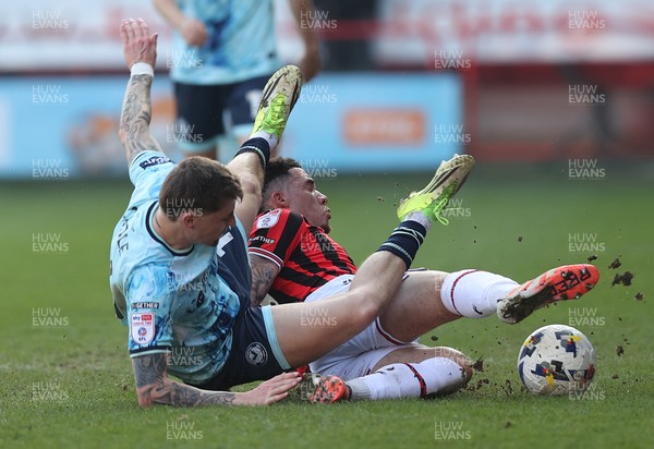 210326 - Walsall v Newport County - Sky Bet League 2 - James Crole of Newport falls over Rico Browne of Walsall FC