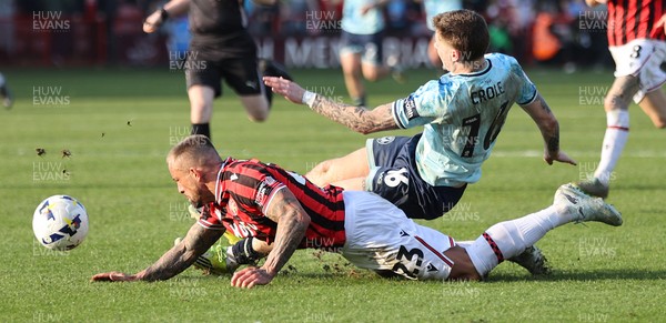 210326 - Walsall v Newport County - Sky Bet League 2 - Harrison Biggins of Newport lands on Alex Pattison of Walsall FC