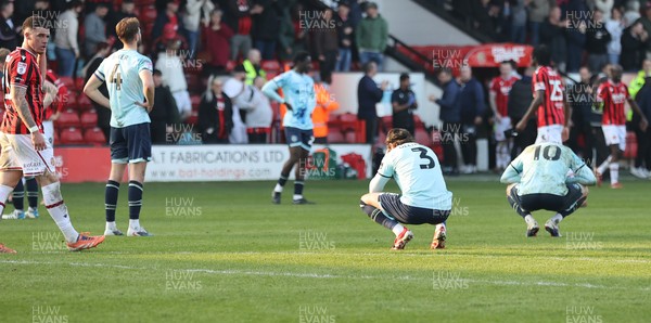 210326 - Walsall v Newport County - Sky Bet League 2 - Anthony Glennon of Newport and Matt Baker of Newport and Harrison Biggins of Newport dejected at the end of the match