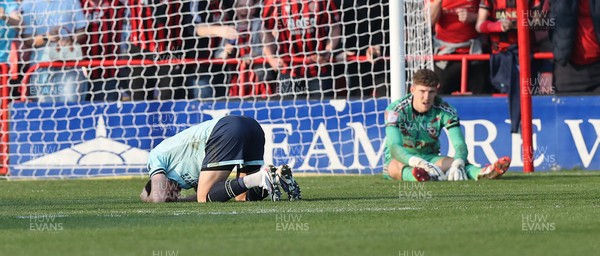 210326 - Walsall v Newport County - Sky Bet League 2 - Tom Davies of Newport and Goalkeeper Jordan Wright are floored with Anthony Glennon of Newport with his face in his shirt