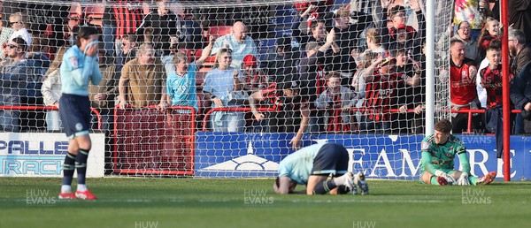 210326 - Walsall v Newport County - Sky Bet League 2 - Tom Davies of Newport and Goalkeeper Jordan Wright are floored with Anthony Glennon of Newport with his face in his shirt