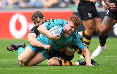 120921 - Wasps v Dragons - Preseason Friendly - Aneurin Owen of Dragons is tackled by Thomas Young of Wasps