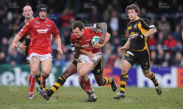 13.01.08 - Wasps v Llanelli Scarlets - Heineken Cup - Llanelli's Mark Jones is tackled by Paul Sackey 