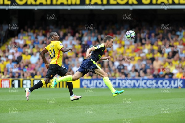 270816 - Watford V Arsenal - PremiershipLaurent Koscielny of Arsenal beats Watfords Odion Ighalo to the ball