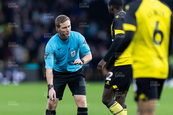 030224 - Watford v Cardiff City - Sky Bet League Championship - Match referee James Linington talks to Ken Sema of Watford 