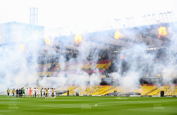 080521 - Watford v Swansea City - Sky Bet Championship - Swansea City players amidst the smoke and fireworks as Watford celebrate promotion