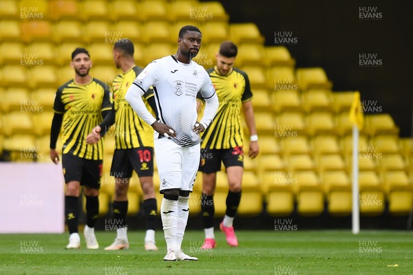 080521 - Watford v Swansea City - Sky Bet Championship - Marc Guehi of Swansea City dejected as Isaac Success of Watford celebrates scoring his side's second goal 