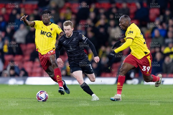 120325 - Watford v Swansea City - Sky Bet League Championship - Lewis O'Brien of Swansea City is challenged by Vakoun Issouf Bayo and Edo Kayembe of Watford