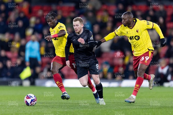 120325 - Watford v Swansea City - Sky Bet League Championship - Lewis O'Brien of Swansea City is challenged by Vakoun Issouf Bayo and Edo Kayembe of Watford