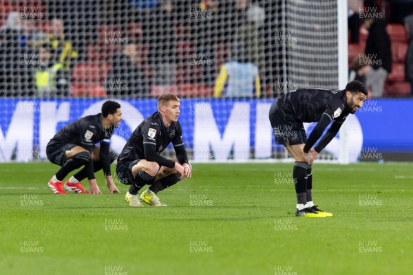 120325 - Watford v Swansea City - Sky Bet League Championship - Players of Swansea City look dejected after their side’s defeat