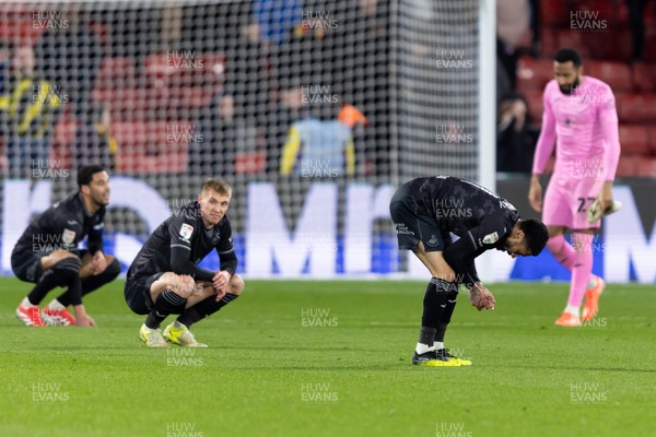 120325 - Watford v Swansea City - Sky Bet League Championship - Players of Swansea City look dejected after their side’s defeat