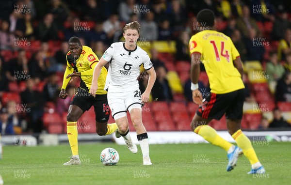240919 - Watford v Swansea City, Carabao Cup, Third Round - George Byers of Swansea City plays the ball past Nathaniel Chalobah of Watford 
